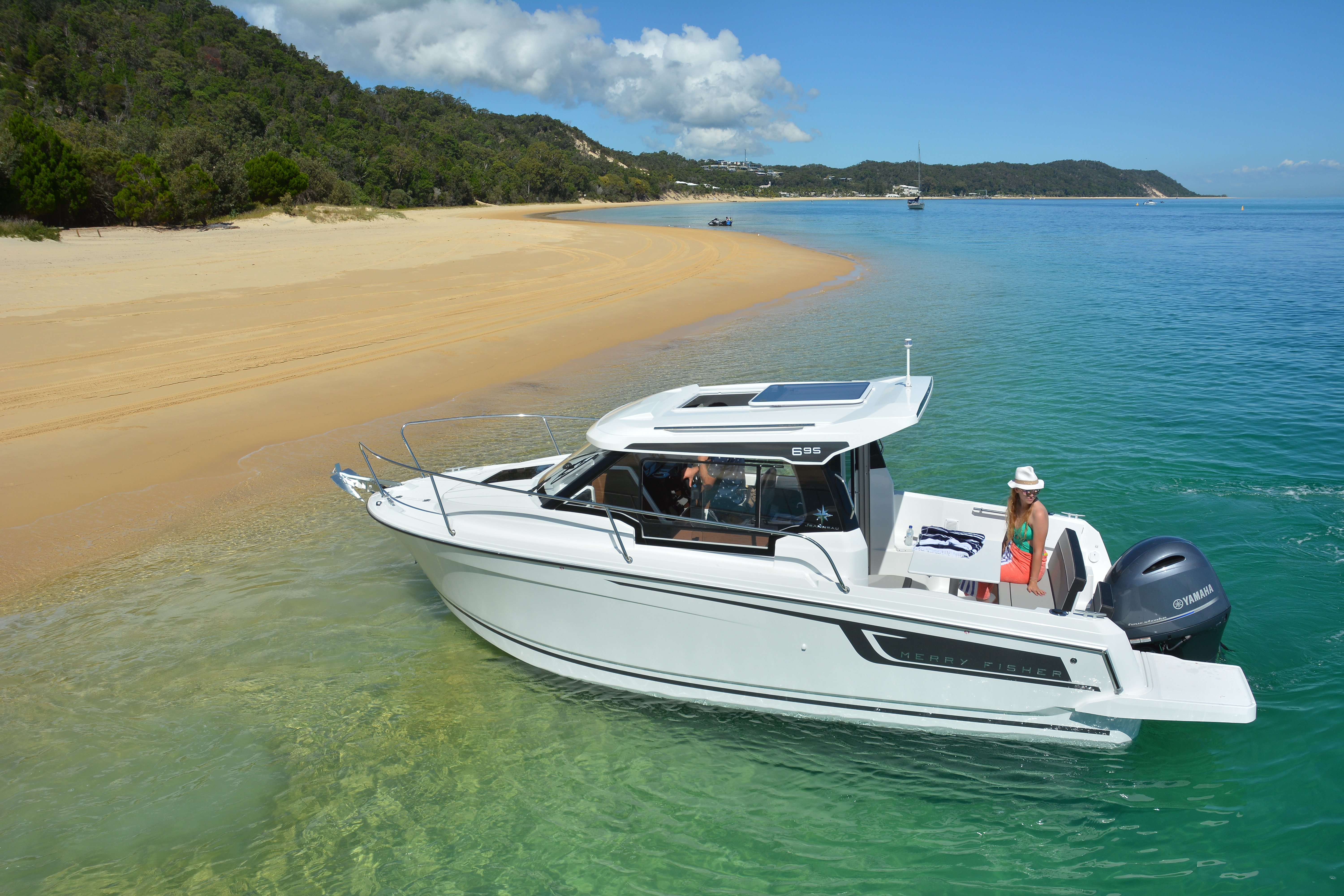The new Merry Fisher 695 Series 2 beached up on a secluded beach with clear blue water all around.