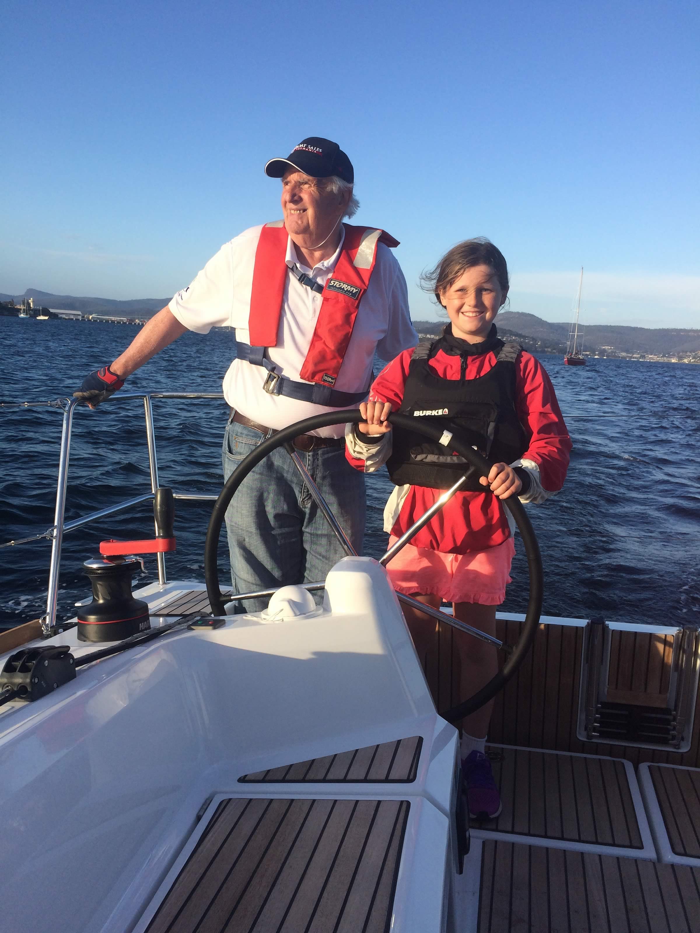 Ruby and grandpa (boat owner), Kevin Jacobson, helming one of the world's southernmost Jeanneau Sun Odyssey 349s.