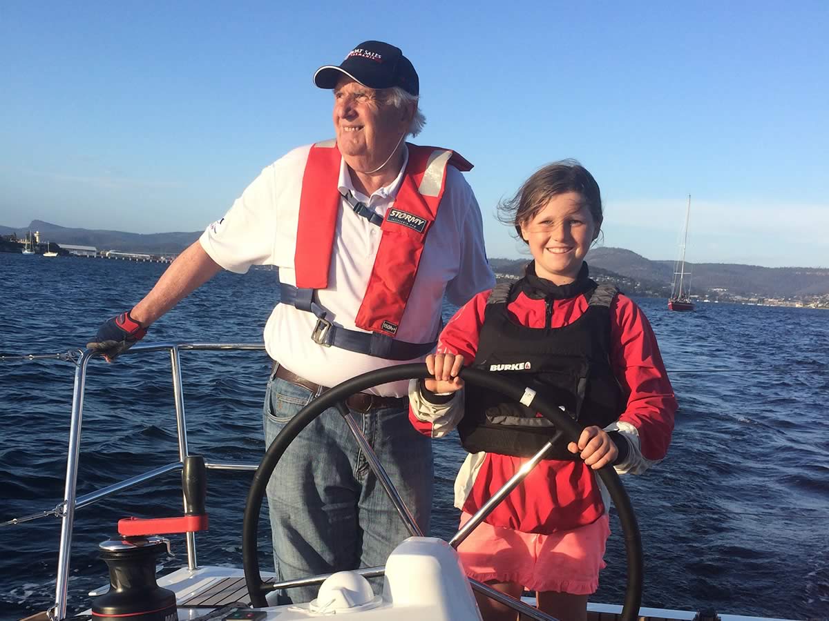 Ruby and grandpa (boat owner), Kevin Jacobson, helming one of the world's southernmost Jeanneau Sun Odyssey 349s.